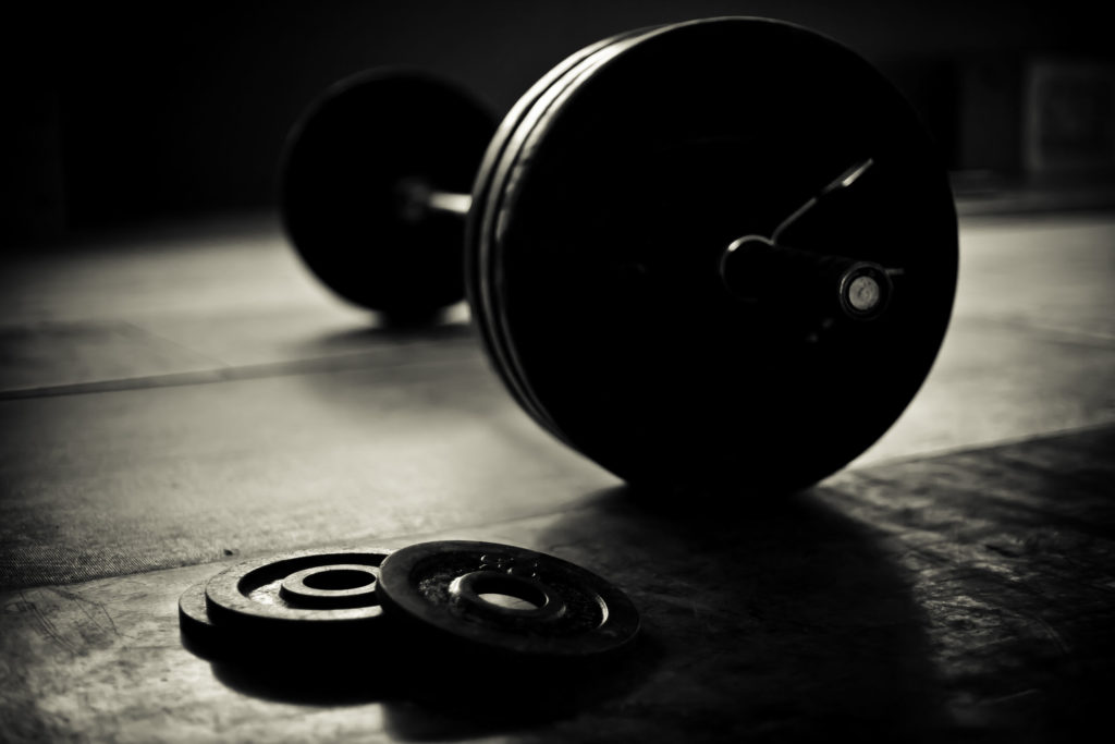 45344440 - barbell and discs in a weightlifting gym