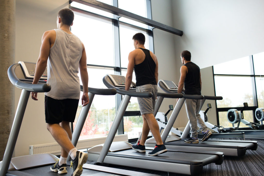 33301123 - sport, fitness, lifestyle, technology and people concept - men exercising on treadmill in gym