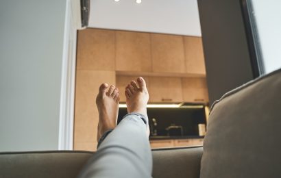 Woman lying with her legs crossed indoors