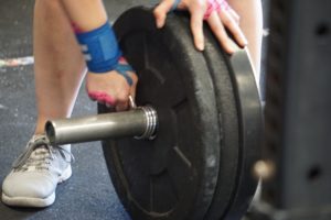 Girl preparing to lift weights.
